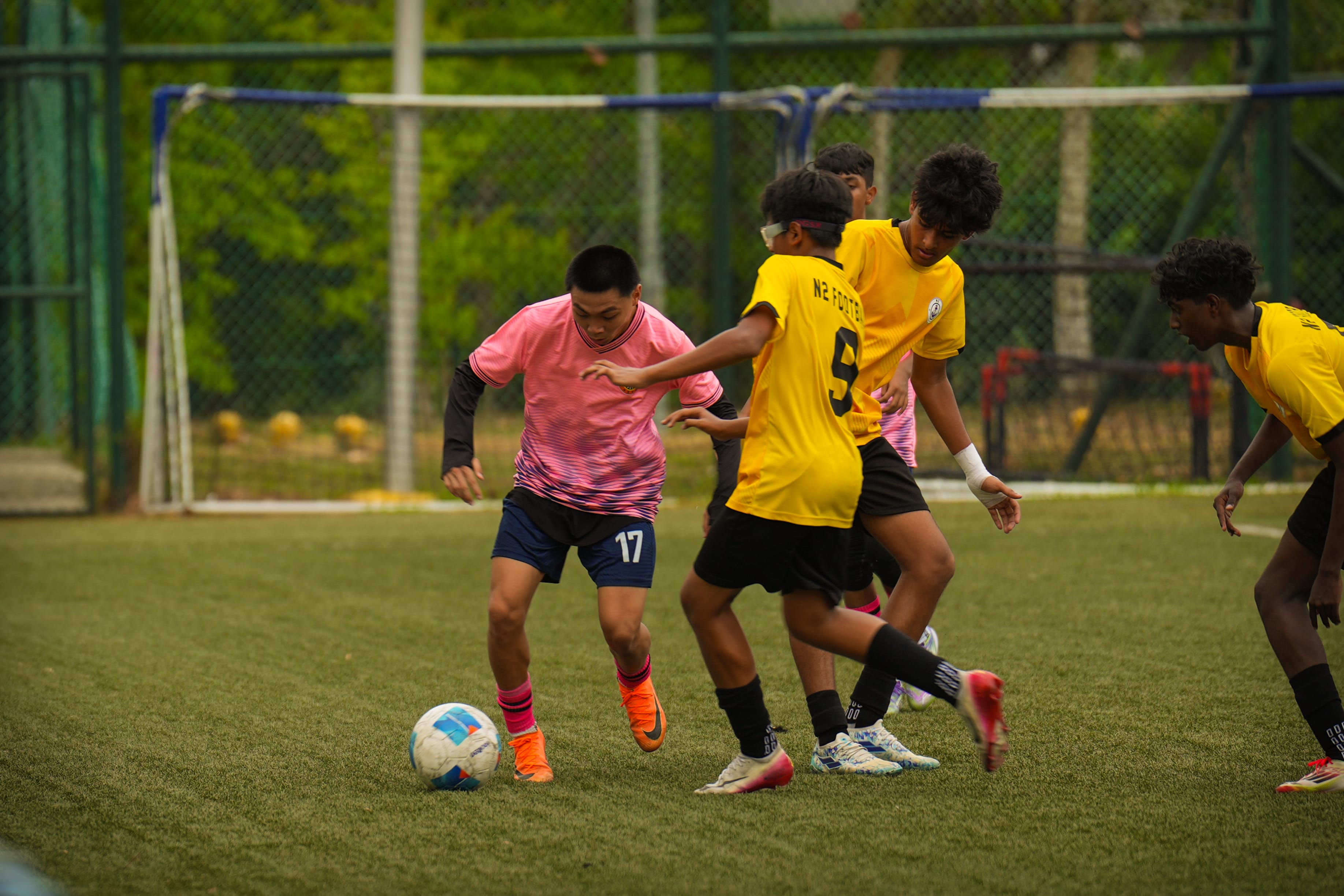 A student tackling a ball during a match